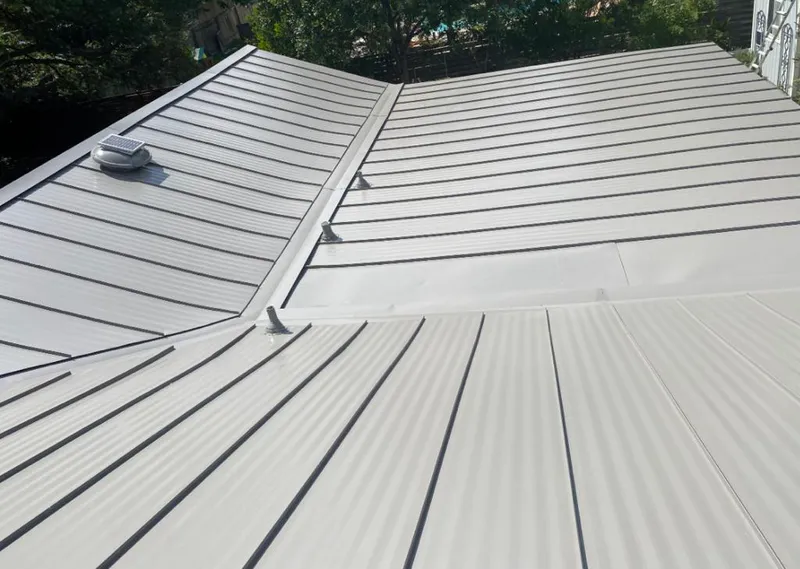 Solar attic fan installed on a metal roof for Roof Ventilation in Ladue